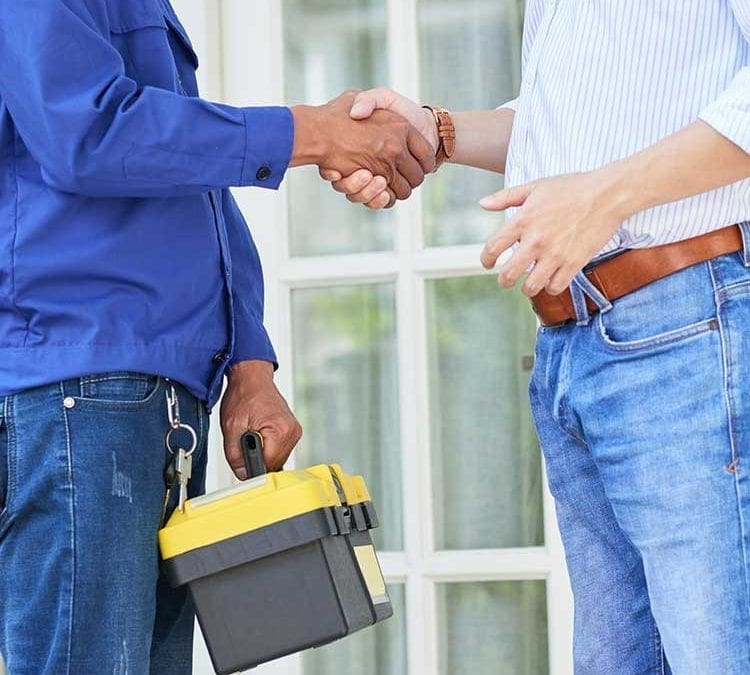Handshake between a homeowner and a Cipriani Remodeling Solutions professional holding a toolbox, symbolizing a trustworthy service agreement.