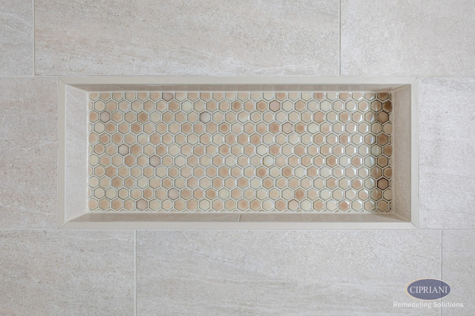 Hexagonal tile shower niche with neutral tones