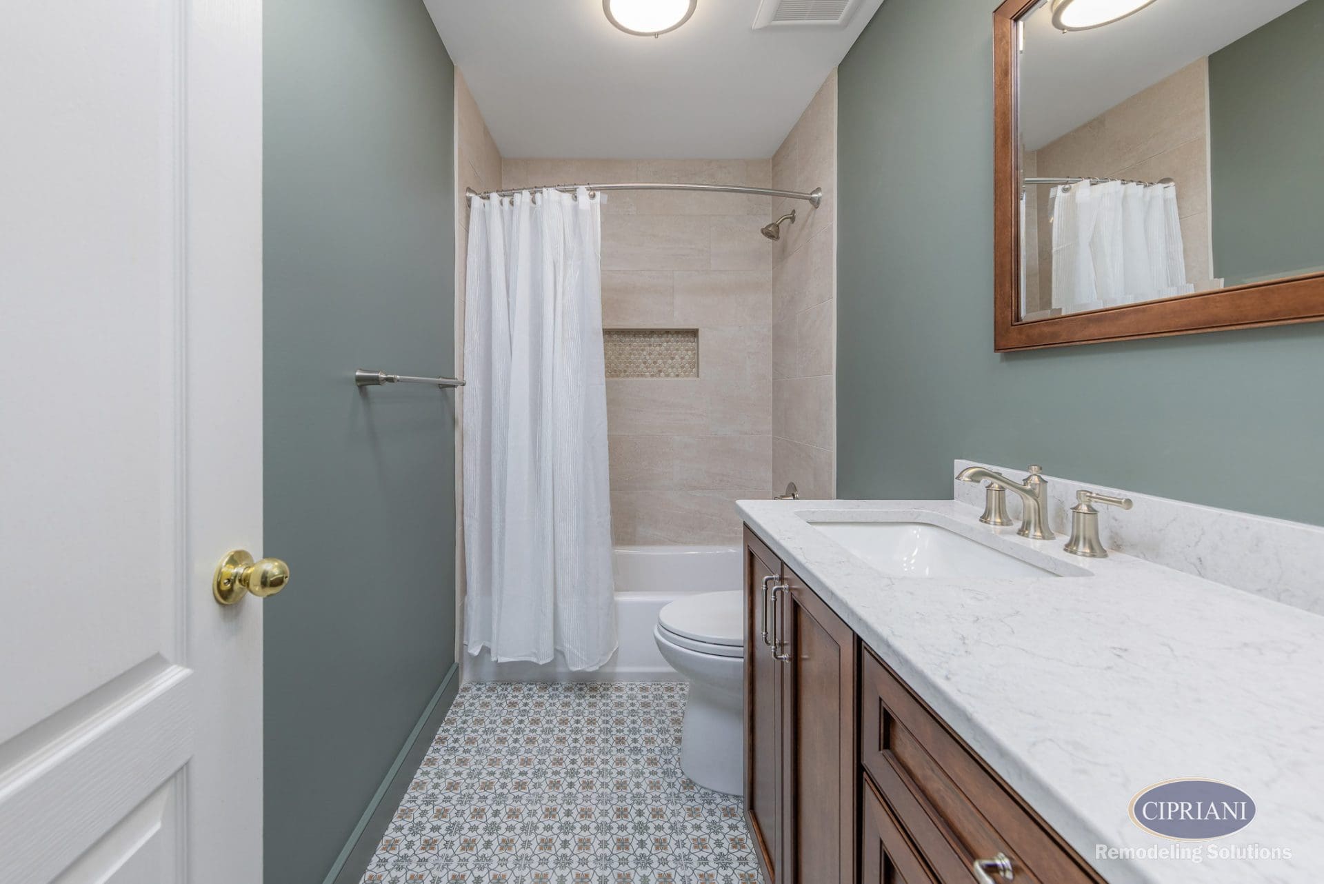 Double vanity with marble top and patterned tile floor in a Cinnaminson bathroom remodel