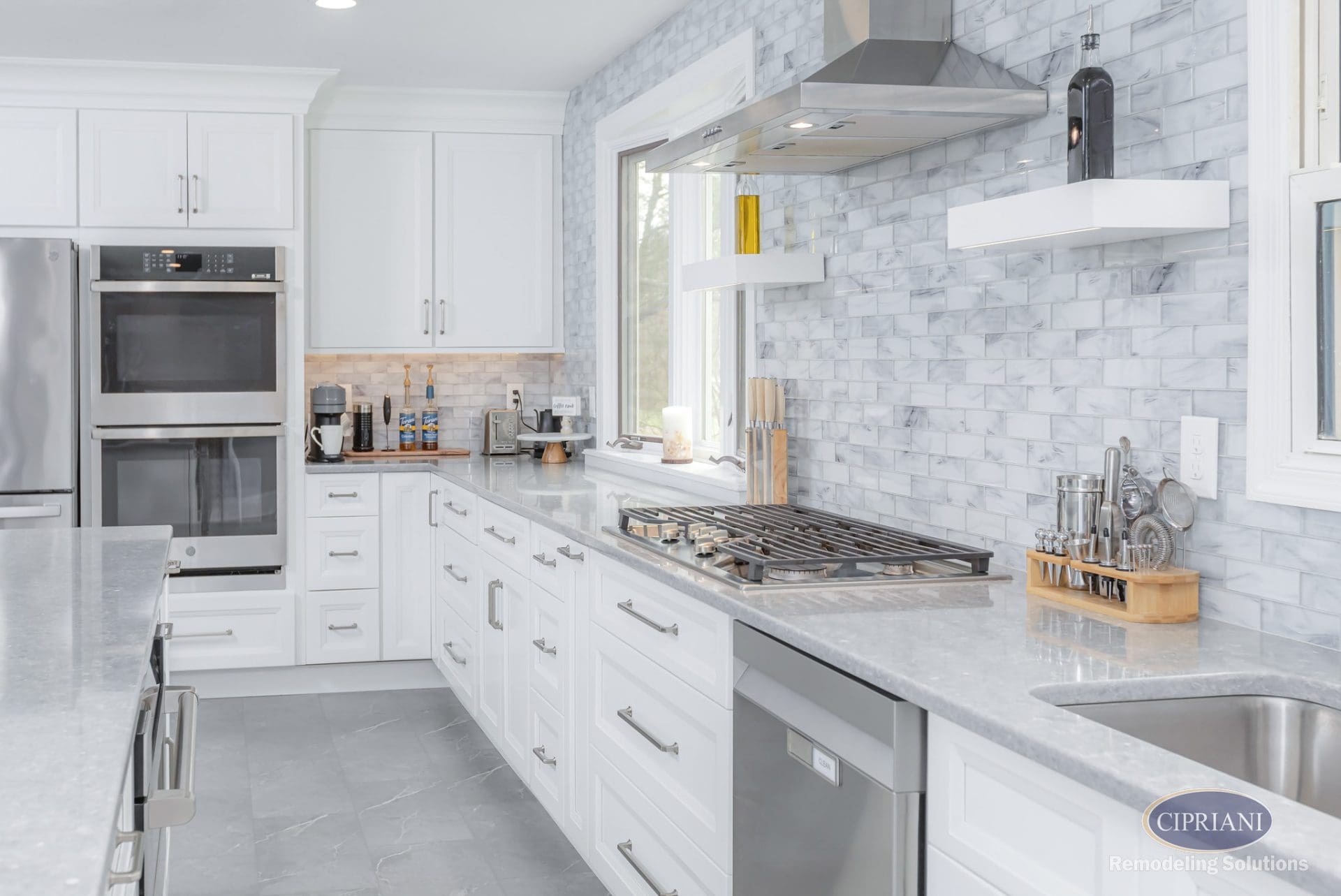 Sleek white cabinetry with under-cabinet lighting and stainless steel appliances