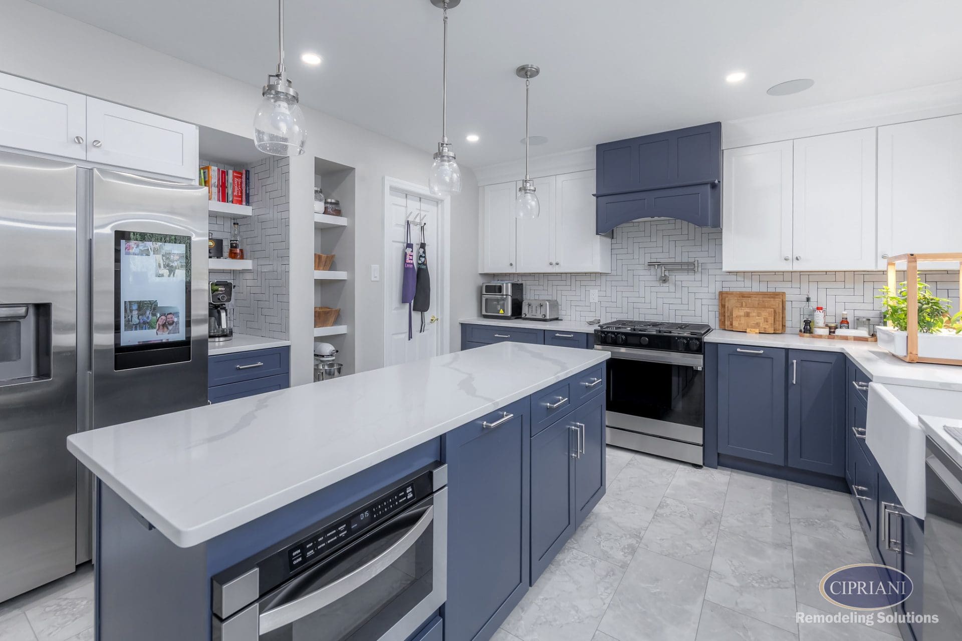 Open kitchen with navy lower cabinets, white uppers, smart fridge, and center island with microwave drawer.