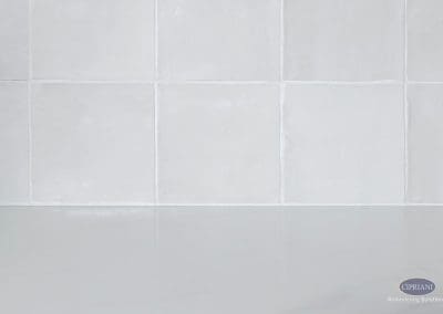White square tile backsplash with subtle texture.