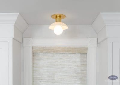 Brass ceiling light with modern globe shade.