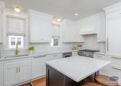 Bright kitchen with white cabinetry, a sleek center island, and natural light filling the space.