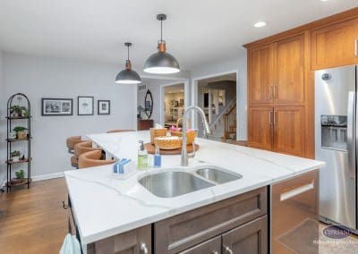 Modern kitchen island with quartz countertop and pendant lighting.