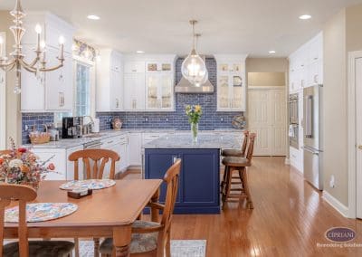 Open kitchen and dining view with navy island, white cabinets, and wood floors in Lumberton NJ kitchen remodel