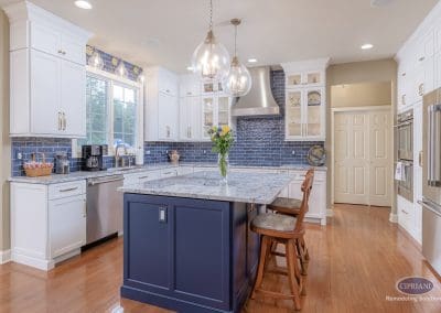 Bright kitchen with navy island, pendant lights, and stainless appliances in Lumberton NJ kitchen renovation