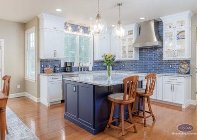 Bright Lumberton kitchen remodel with navy island, pendant lights, and white cabinetry