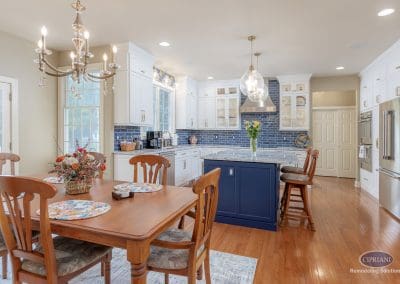 Lumberton kitchen remodel with navy island, dining area, and chandelier lighting