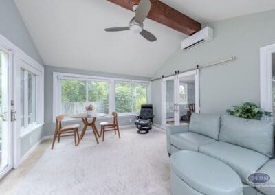 Open sunroom with vaulted ceiling, ceiling fan, and sliding glass doors A bright sunroom featuring a vaulted ceiling with exposed beam detail, integrated ceiling fan, large windows, and sliding glass doors that connect the space to the rest of the home.