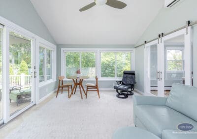 Flexible sunroom layout with seating, dining area, and sliding doors An open sunroom layout featuring a small dining table, lounge seating, and sliding glass doors that connect the addition to both the deck and adjacent living spaces.