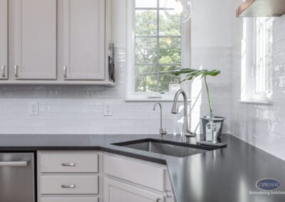 Kitchen sink detail with black countertops, white subway tile backsplash, and modern faucet in a Moorestown kitchen remodel.