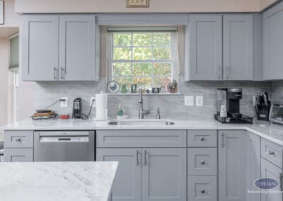 Gray Shaker Sink Wall with Window – A Sicklerville kitchen sink wall featuring gray shaker cabinetry, a centered window, quartz countertops, and a clean, practical workspace designed for daily use.