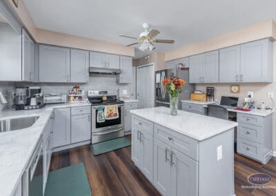 Gray Shaker Kitchen with Island – A Sicklerville kitchen featuring gray shaker cabinetry, a central quartz island, stainless steel appliances, and an efficient layout designed for everyday living.
