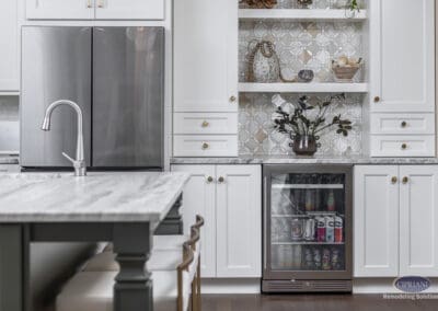 Timeless Gathering Mount Laurel Kitchen Remodel: Custom beverage center with marble countertop, decorative open shelving, patterned tile backsplash, and built-in beverage refrigerator for entertaining.