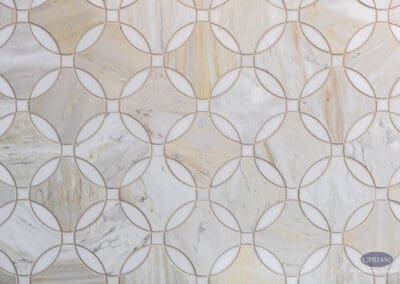 Geometric Marble Tile Backsplash Detail: Close-up of circular geometric marble tile pattern featuring soft neutral veining and warm tones used as a decorative kitchen backsplash.