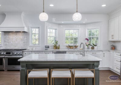 Timeless Gathering Mount Laurel Kitchen Remodel: Wide kitchen view with marble island, layered seating, custom white cabinetry, and triple-window backsplash creating a bright and inviting gathering space.