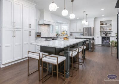 Timeless Gathering Mount Laurel Kitchen Remodel: Expansive dual-island kitchen with marble countertops, custom white cabinetry, layered seating, and statement pendant lighting designed for entertaining.