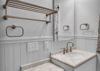 Bathroom vanity with integrated countertop, undermount sink, wall mirror, and towel shelf