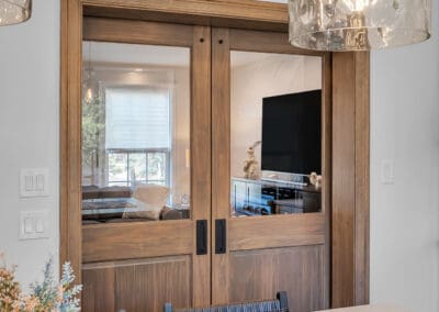 Wood sliding doors with glass panels connecting kitchen to living room