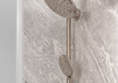Shower system with rain shower head and handheld sprayer on sliding bar