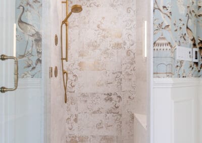 Walk-in shower with brass fixtures and decorative tile in Mullica Hill bathroom remodel