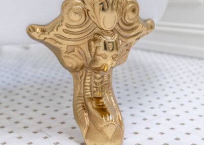 Decorative gold clawfoot tub leg on white mosaic bathroom floor in Mullica Hill remodel