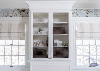 Custom white built-in linen cabinet with wire mesh doors in Mullica Hill bathroom remodel