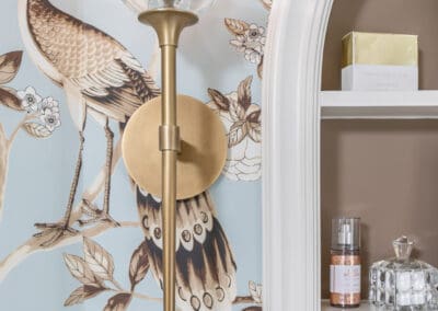 White vanity sink with brass faucet and blue bird wallpaper in Mullica Hill bathroom