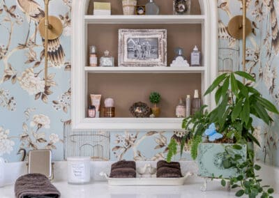Arched bathroom niche with decorative shelving and blue chinoiserie wallpaper in Mullica Hill remodel