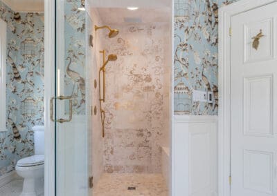 Glass walk-in shower with brass fixtures and patterned tile in Mullica Hill bathroom remodel