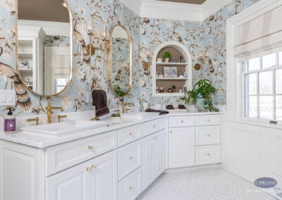 Custom double vanity with brass fixtures and decorative wallpaper in Mullica Hill bathroom remodel