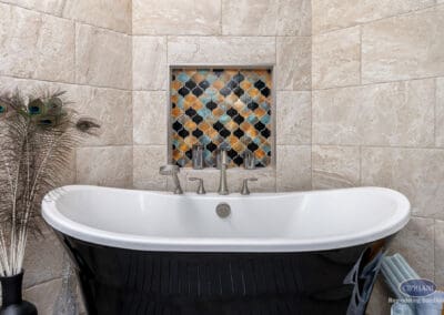 Freestanding black soaking tub with decorative tile niche in Wenonah NJ bathroom remodel