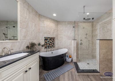 Freestanding black soaking tub, tile niche, and glass walk-in shower in Wenonah NJ bathroom remodel