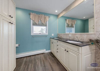 Double vanity with large mirror and teal accent wall in Wenonah NJ bathroom remodel